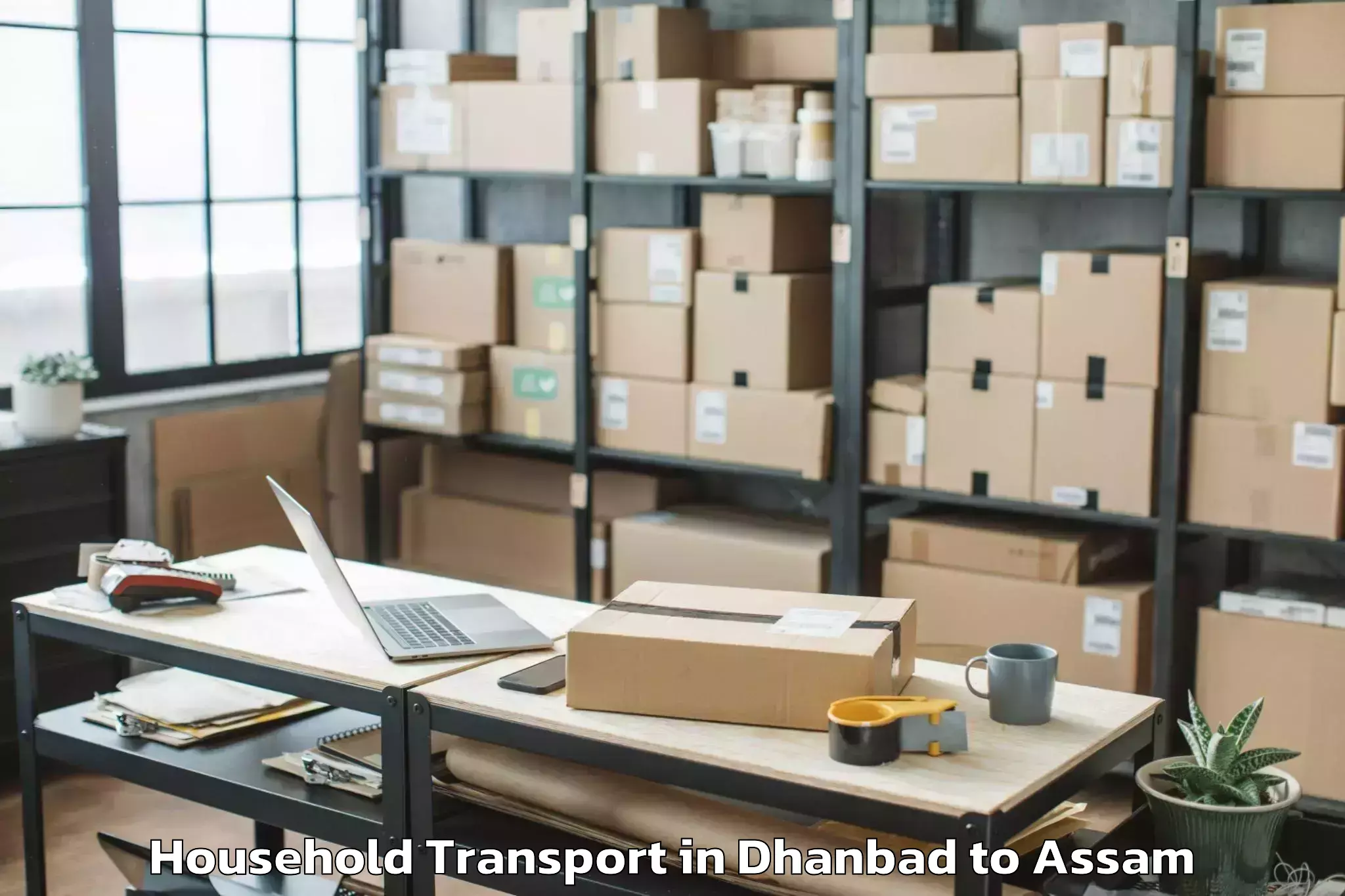 Book Dhanbad to Chariduar Household Transport Online